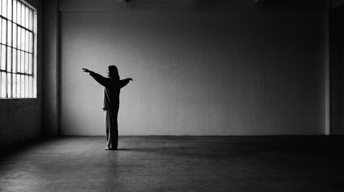 Person practising qigong alone in a large empty room